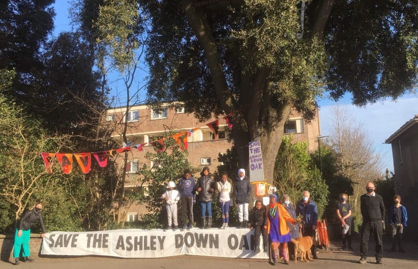 Community standing by the Ashley Down Oak with banner.