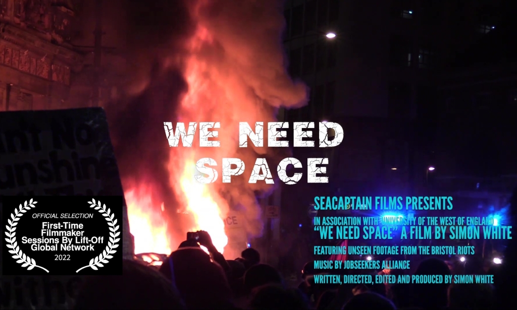 The words "We Need Space" against a backdrop of flames.